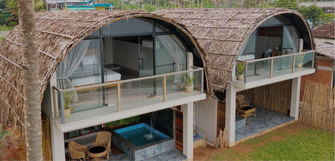 Aerial view of Tira Beach Resort cottage surrounded by lush greenery